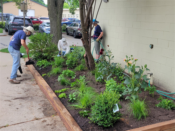 Volunteers planting garden outside Brinton Community Center Volunteers planting garden outside Brinton Community Center